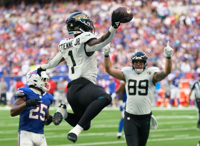 Oct 8, 2023; London, United Kingdom; Jacksonville Jaguars running back Travis Etienne Jr. (1) jumps into the end zone for a touchdown during the second half of an NFL International Series game against the Buffalo Bills at Tottenham Hotspur Stadium. Mandatory Credit: Peter van den Berg-USA TODAY Sports